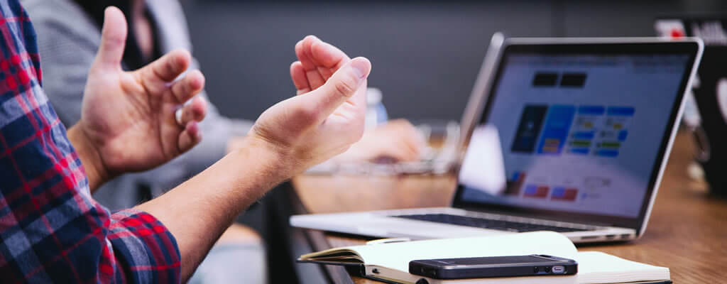 2 people sitting at desk viewing business listings on a directory website